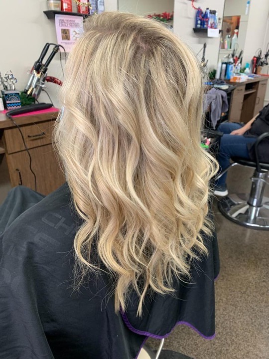 Long blonde hair with soft layered waves
