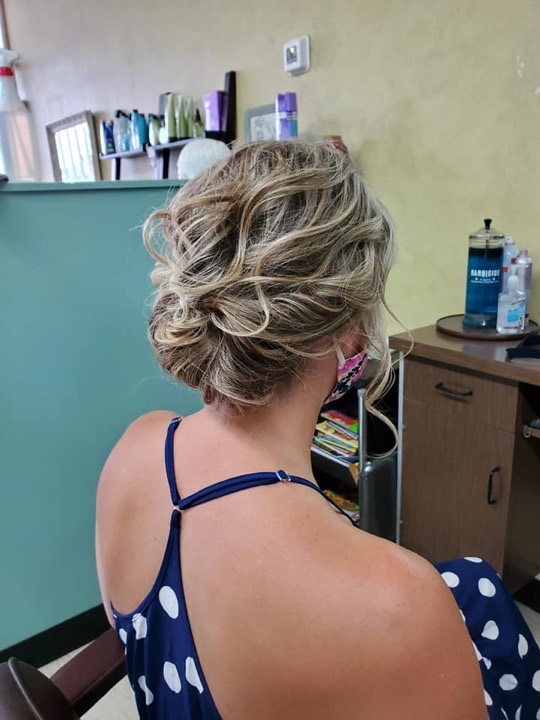 Textured blonde updo with loose face-framing curls